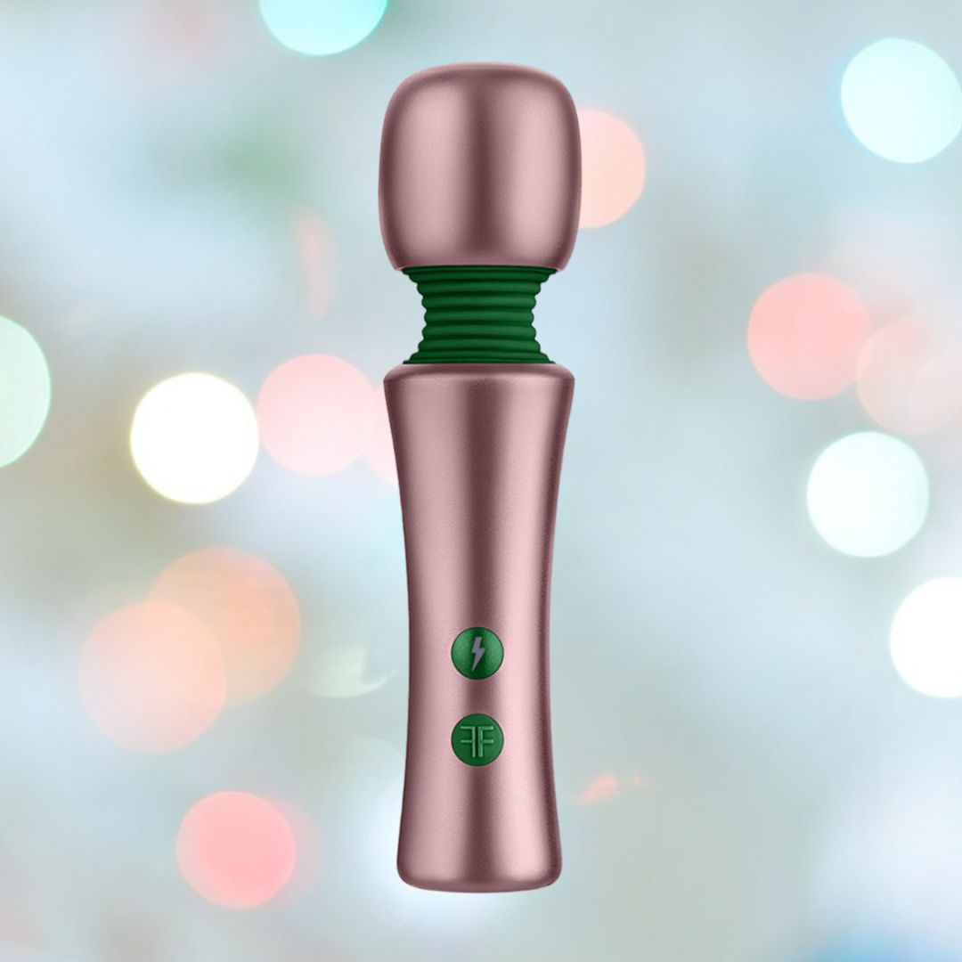 A rose gold Femme Funn Bougie Wand Massager by Femme Funn, boasting a flexible silicone neck and two green buttons on the handle, is showcased against a soft, out-of-focus backdrop with multicolored bokeh lights.