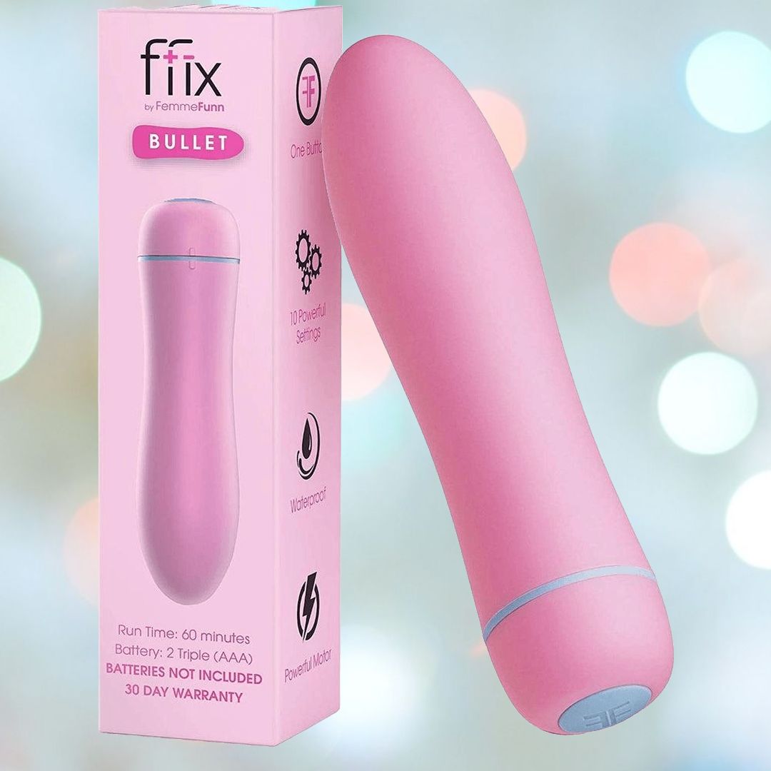 The Femme Funn FFIX Bullet Vibrator in pink is showcased next to its packaging box, highlighting its renowned powerful vibration and waterproof design. A softly blurred background with soothing pastel colors complements the display.