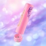The FemmeFunn Anniversary Ultra Bullet Orchid, a pink, floral-designed travel vibrator from Femme Funn, is displayed with its cap off against a soft purple and blue bokeh background.