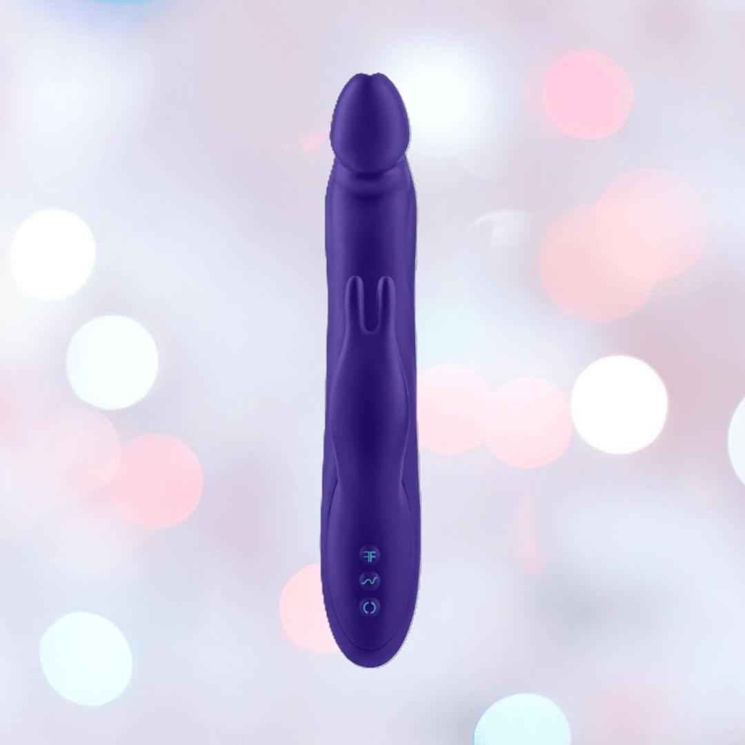 The Femme Funn Booster Rabbit XL: Deluxe Rotating Vibrator with Boost Mode in dark purple stands upright against a soft, pastel bokeh background.