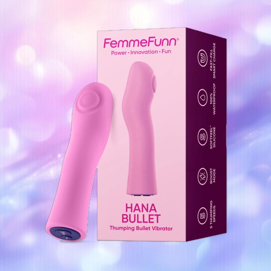 A pink Femme Funn Hana Thumping Bullet is displayed beside its purple box, both set on a softly blurred purple and blue background.