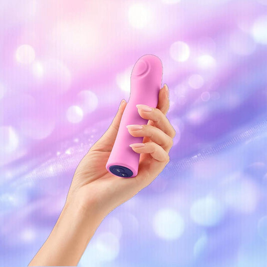 A hand holding the Femme Funn Hana Thumping Bullet Pink, a waterproof bullet vibrator by Femme Funn, against a softly blurred purple and pink background. 1080