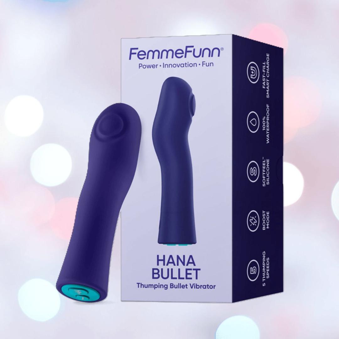 A Femme Funn Hana Thumping Bullet Vibrator in dark purple stands by its box, highlighting waterproof and rechargeable features, with a blurred pastel background.