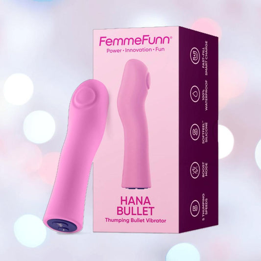 The Femme Funn Hana Thumping Bullet Vibrator in pink stands beside its box, featuring highlighted details. This waterproof silicone vibe is displayed on a soft pastel background with gentle circular light spots. 1080