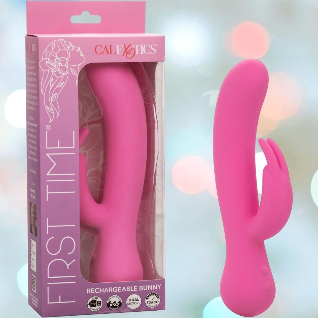 A pink, silicone rechargeable bunny vibe with a curved shape and bunny-ear clitoral stimulator sits by its box labeled "First Time Rechargeable Bunny with Turbo Boost Accelerated Speeds" from CalExotics.