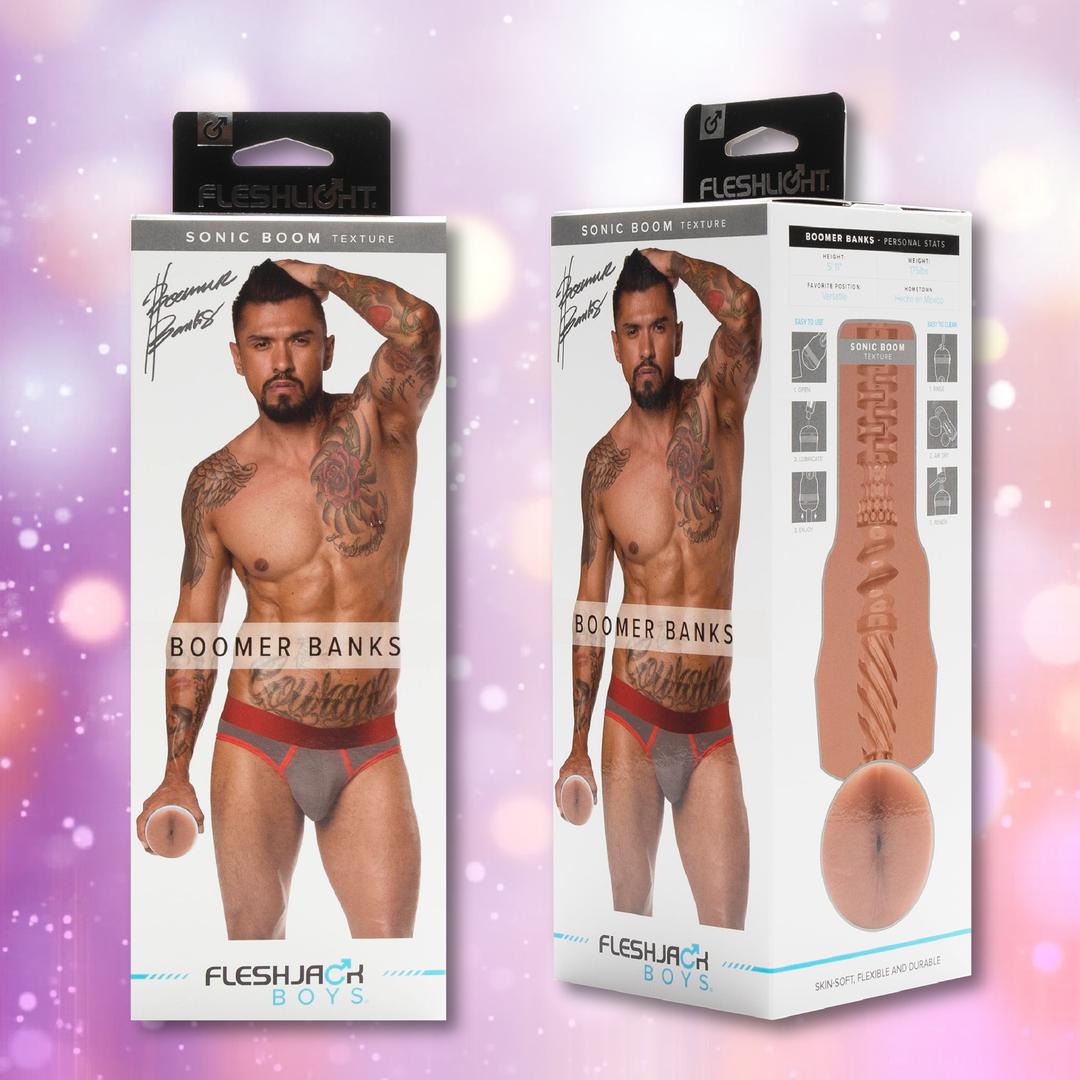 Two boxes show tattooed model Boomer Banks in red and gray briefs holding the Fleshlight Fleshjack Boys Boomer Banks: Realistic Male Masturbator Cake Butt. “Boomer Banks” and Sonic Boom texture details appear on each package side.