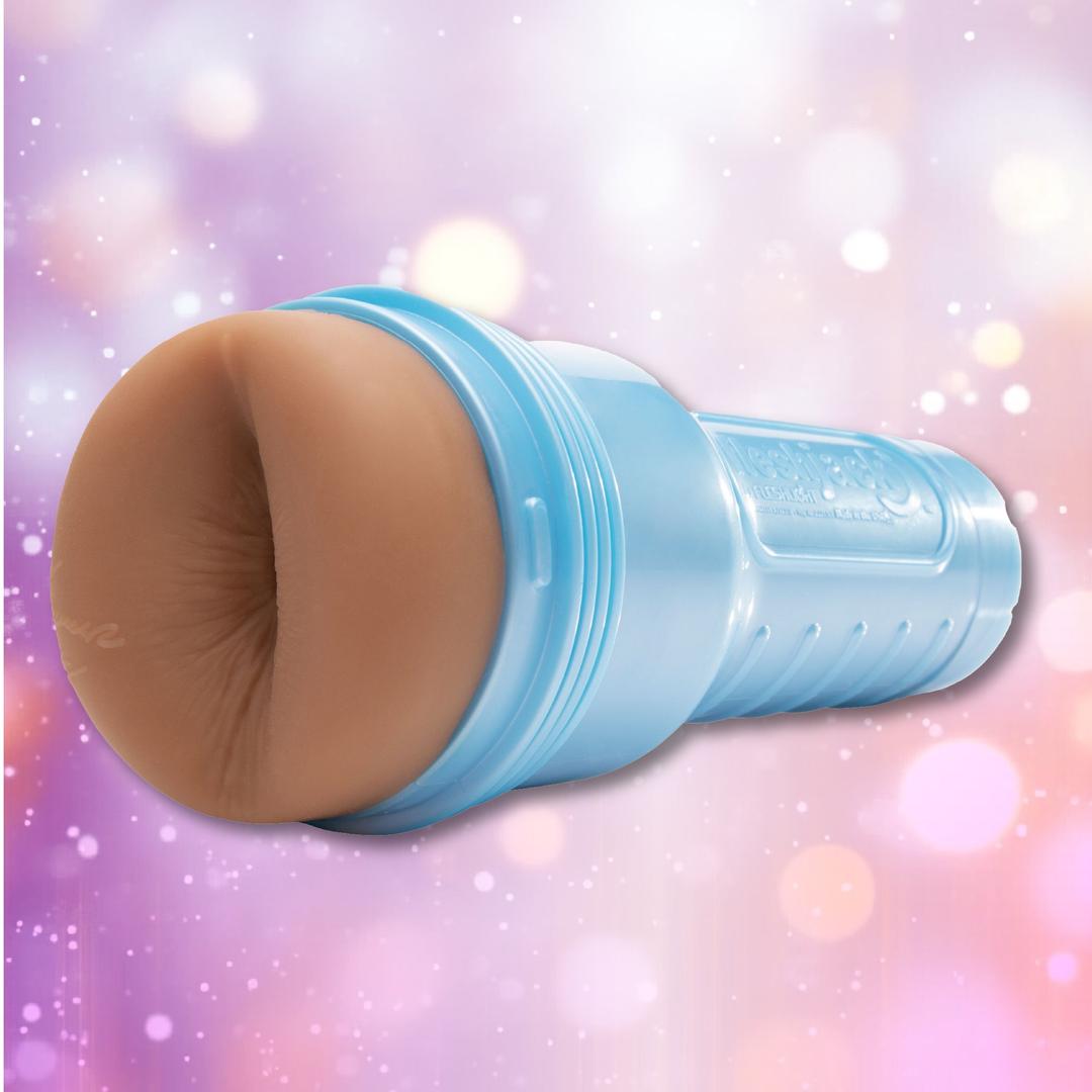 A blue Fleshlight Fleshjack Boys Boomer Banks: Realistic Male Masturbator Cake Butt, shaped to resemble human anatomy, displayed against a backdrop of blurred pink, purple, and white bokeh lights.