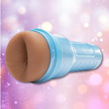 A blue Fleshlight Fleshjack Boys Boomer Banks: Realistic Male Masturbator Cake Butt, shaped to resemble human anatomy, displayed against a backdrop of blurred pink, purple, and white bokeh lights.