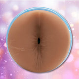 Close-up of the Fleshlight Fleshjack Boys Boomer Banks: Realistic Male Masturbator Cake Butt, highlighting its lifelike anal opening framed in light blue, set against a soft purple and pink bokeh background.
