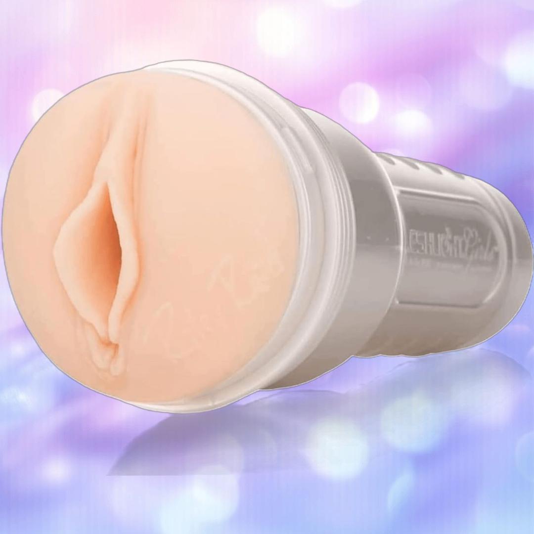 A close-up of a condom next to the lifelike SuperSkin sleeve of the Fleshlight Girls: Riley Reid Utopia by Fleshlight.