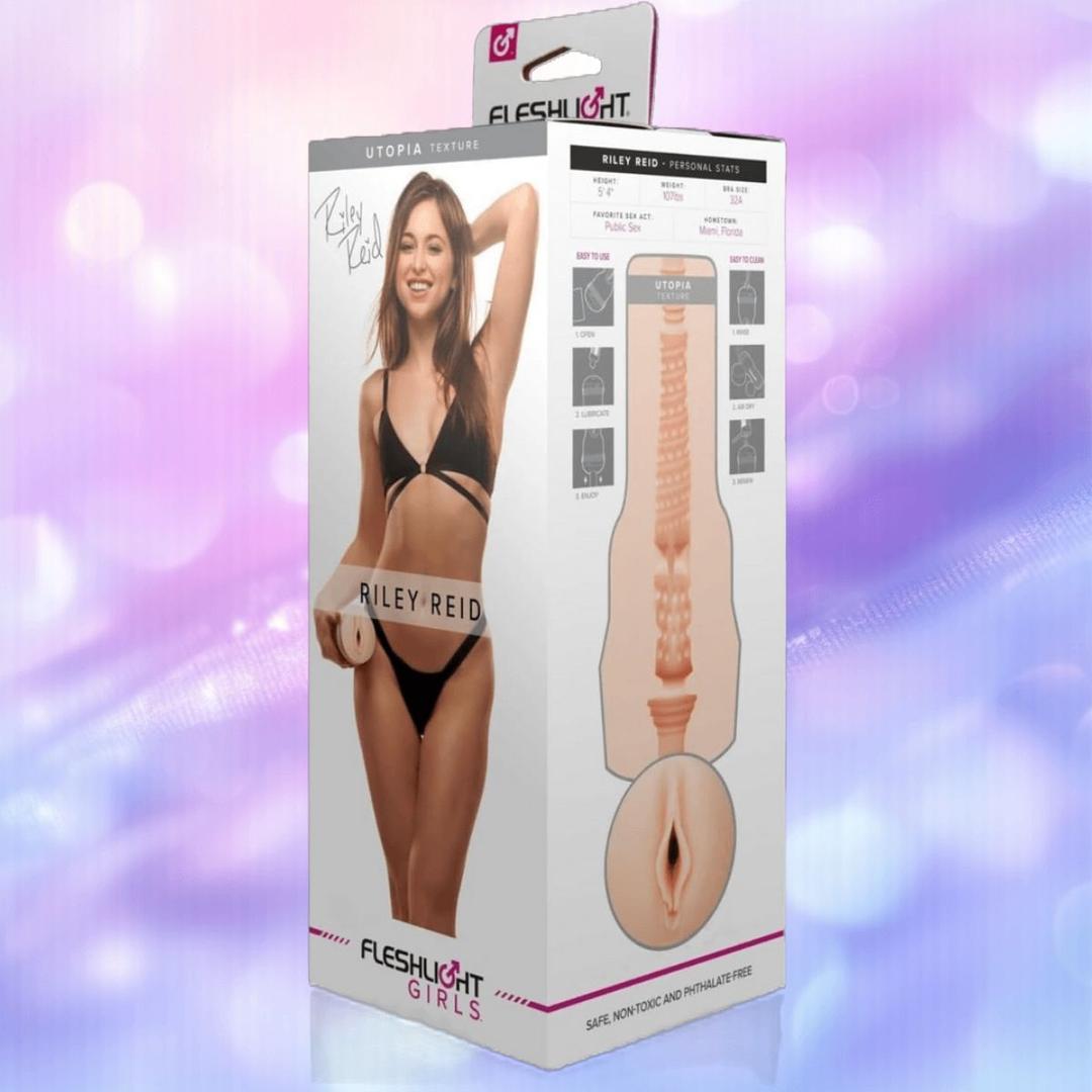 The Fleshlight Girls: Riley Reid Utopia retail box by Fleshlight features Riley Reid in black lingerie and a diagram of the Utopia sleeve’s lifelike SuperSkin texture on a pastel purple background.