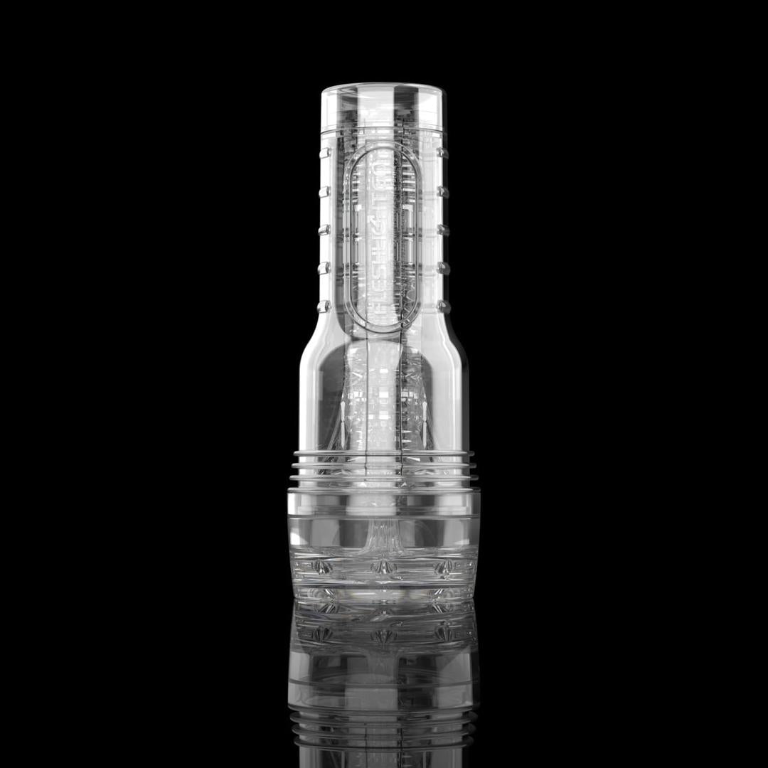 The Fleshlight GO Torque Portable Stroker Male Masturbation Toy by Fleshlight is a clear, cylindrical stroker with a textured interior, shown standing upright on a reflective black surface against a dark background.