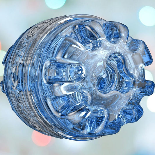 The Fleshlight Quickshot Turbo Open-Ended Masturbating Sleeve, a meticulously designed translucent blue plastic accessory with intricate grooved patterns and a hollow center, is showcased against a softly blurred background highlighted by pastel lights. 1080