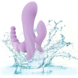 The CalExotics Flex Bend & Hold Triple Rumbler, a purple silicone vibrator with multiple extensions, is shown splashing into clear water to highlight its waterproof feature.