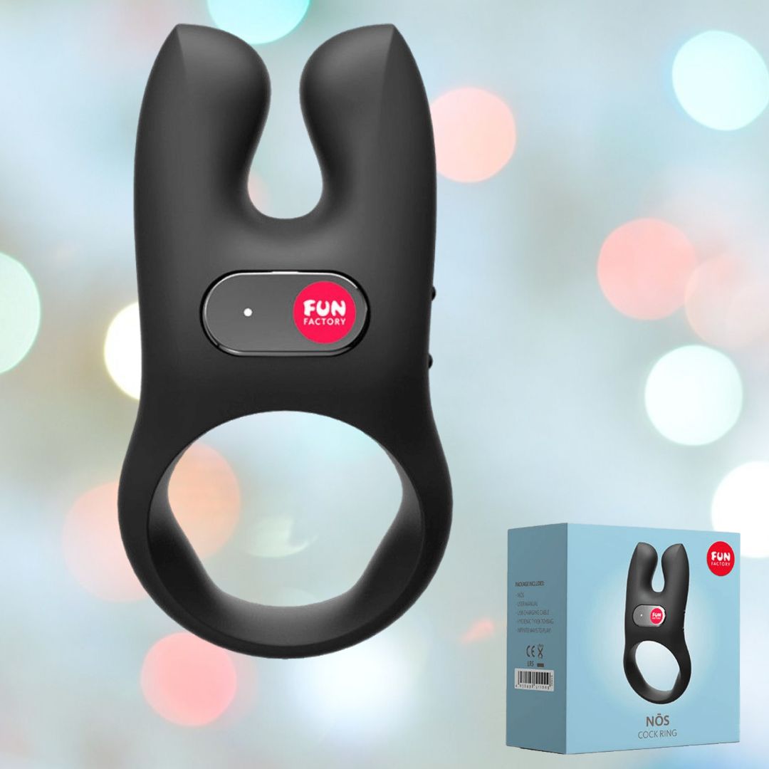 The Fun Factory NOS Vibrating Silicone Cock Ring in black showcases a distinctive U-shaped design with dual-motor vibrations and a central control button. Accompanying the product, the box is elegantly displayed against a gentle backdrop of blurred circular lights, suggesting hands-free orgasms.