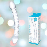 A textured, translucent white double-sided glass product, known as the Gläs 10" "Double Trouble" Double-Sided Glass Dildo, is elegantly displayed alongside its packaging against a colorful backdrop. The package features blue and black text detailing its G-spot massage capabilities.