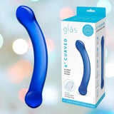 The Gläs 6" Curved G-Spot Blue Glass Dildo shimmers elegantly within its packaging, showcasing its unique hand-blown design. The box emphasizes features such as a luxury satin storage bag and displays the product beautifully against a soft, colorful backdrop.