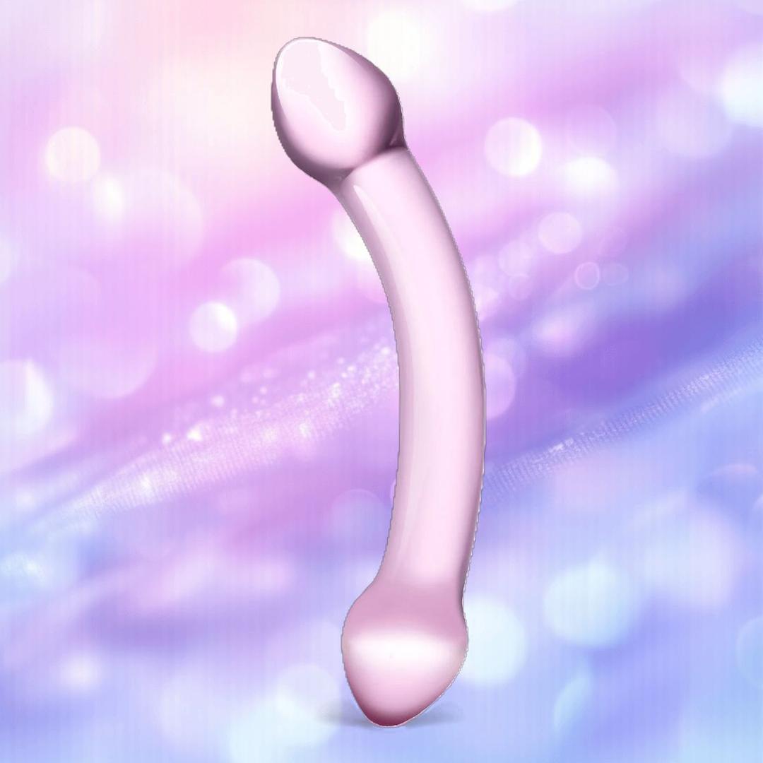 The Gläs Double Trouble Purple Dildo by Gläs is a smooth, curved glass toy with rounded ends, shown against a soft pastel background—ideal for g-spot stimulation or temperature play.