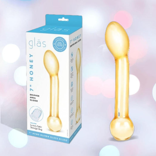 The Gläs Honey Dripper 7" Double Ended Glass Anal and G-Spot Dildo from Gläs is shown beside its packaging, which highlights product details and an image, all set against a soft pastel background. 1080