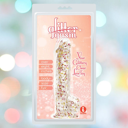 The Icon Brands Glittergasm Dong - Red and Orange Swirl 8" is shown in its package against a soft pastel bokeh background, featuring "glittergasm," "over eight inches," "body-safe tpr," and "Your Glittery Clear Love Toy. 1080