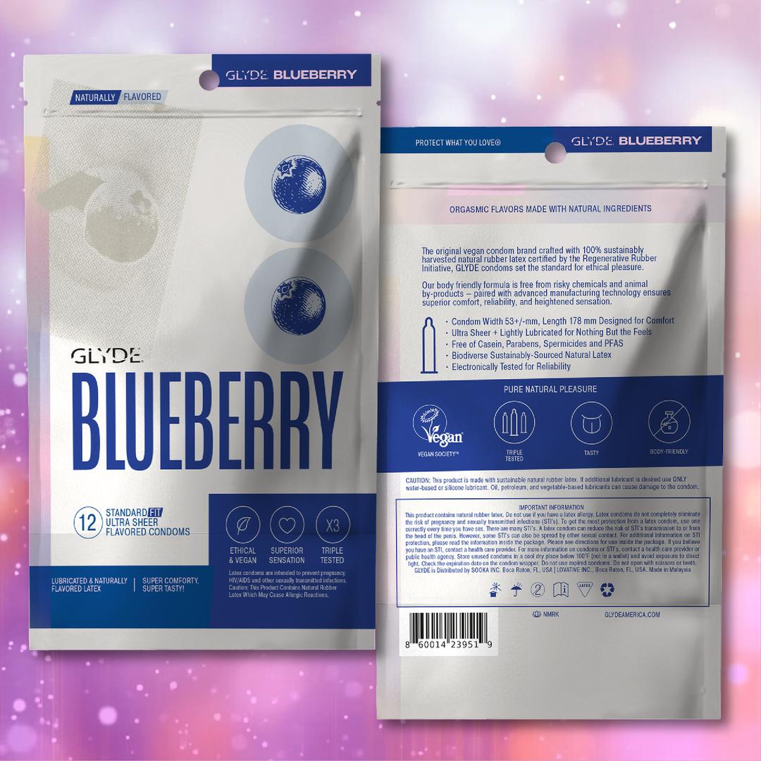 Front and back of a Glyde Organic "Blueberry" Flavored Condoms 🫐 package. The front features vegan, organic highlights with blueberry art; the back details ingredients, certifications, and product info on a blurred pink-purple background.