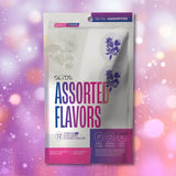 A box of Glyde Natural Flavors Condoms with 5 Flavors (12-Pack) is shown against a pink and purple bokeh background. The packaging notes they are vegan, made from natural latex, ethically produced, and triple-tested for quality.