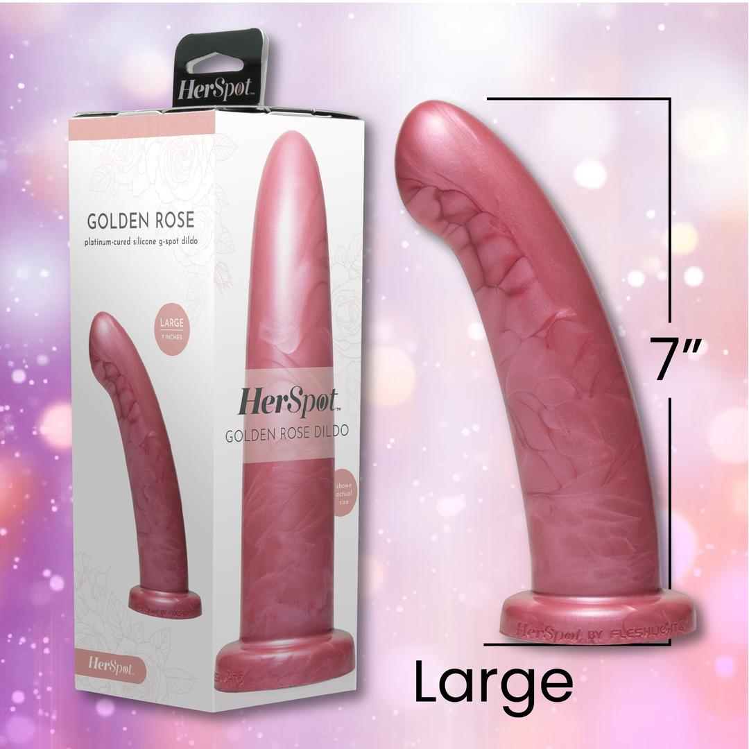 The Fleshlight HerSpot Golden Rose Dildo by Fleshlight, shown in "Large" (7-inch), features a pink, curved design made from platinum-cured silicone. It's pictured next to its box on a shimmering light background with sparkling bokeh.