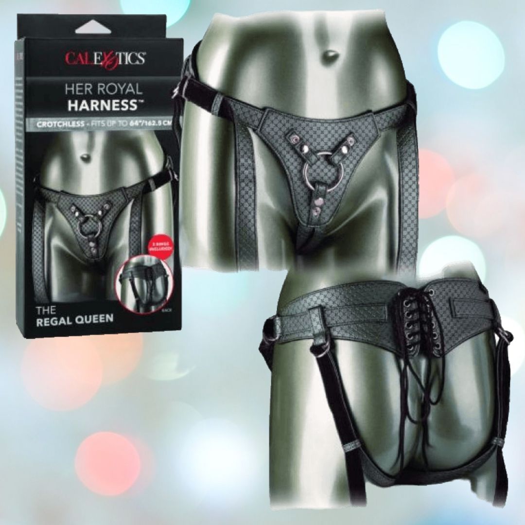 The image features "Her Royal Harness The Regal Queen Pewter" by CalExotics, a black leather crotchless harness perfect for premium probe play. It includes a heart ring detail at the front and a lace-up design at the back. To the left of the harness, you can see its packaging, aptly named "The Regal Queen.