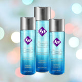 Three bottles of ID Glide Natural Feel Water-Based Lubricant by ID Lubricants are showcased against a vibrant, blurred background. The blue bottles boast purple logos and white text, highlighting qualities such as "hypoallergenic" and "water-based," ideal for those with sensitive skin looking for a natural feel lubricant.