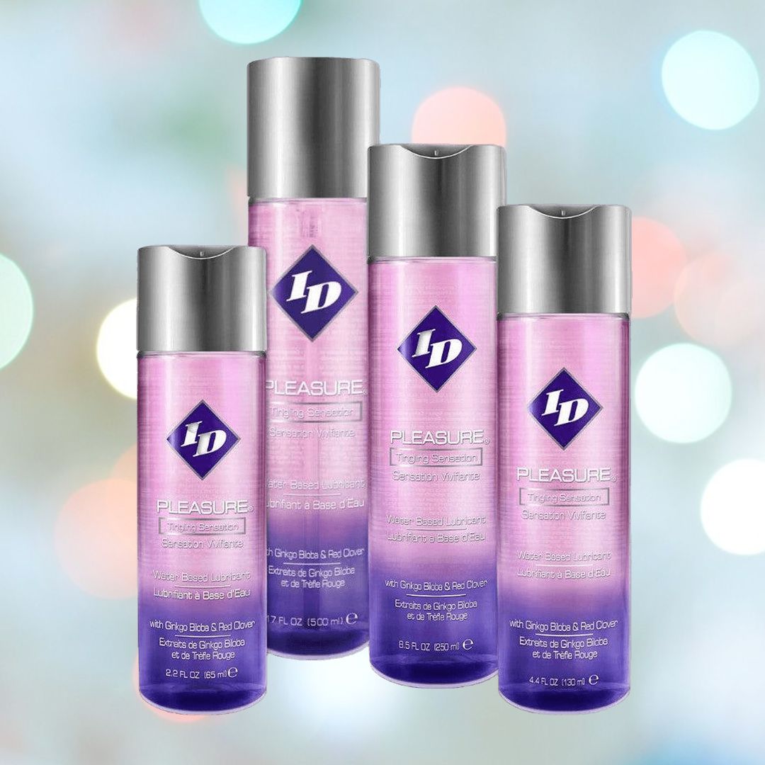 Four bottles of ID Lubricants' Pleasure Tingling Sensation Personal Lubricant, renowned for its enduring formula and tropical fragrance, are arranged against a softly blurred background. The pink bottles with gray caps emphasize their features in both English and Spanish.