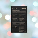 The LELO F1S V3 Male Masturbator Red from LELO features packaging with a sleek black design, enriched with detailed information about its advanced smart technology. The softly blurred background adorned with pastel bokeh lights adds to the allure of this cutting-edge male pleasure device.