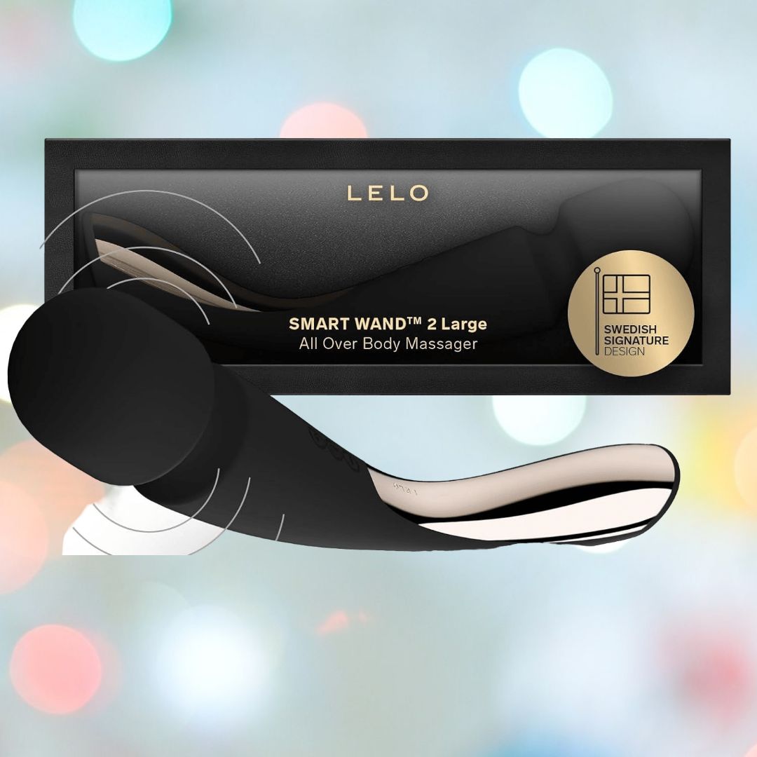 The LELO Smart Wand 2 Large - Luxury Wand Massager Black by LELO is displayed before its packaging, set against a blurred pastel background with soft circular lights—ideal for relaxation and sensual pleasure.