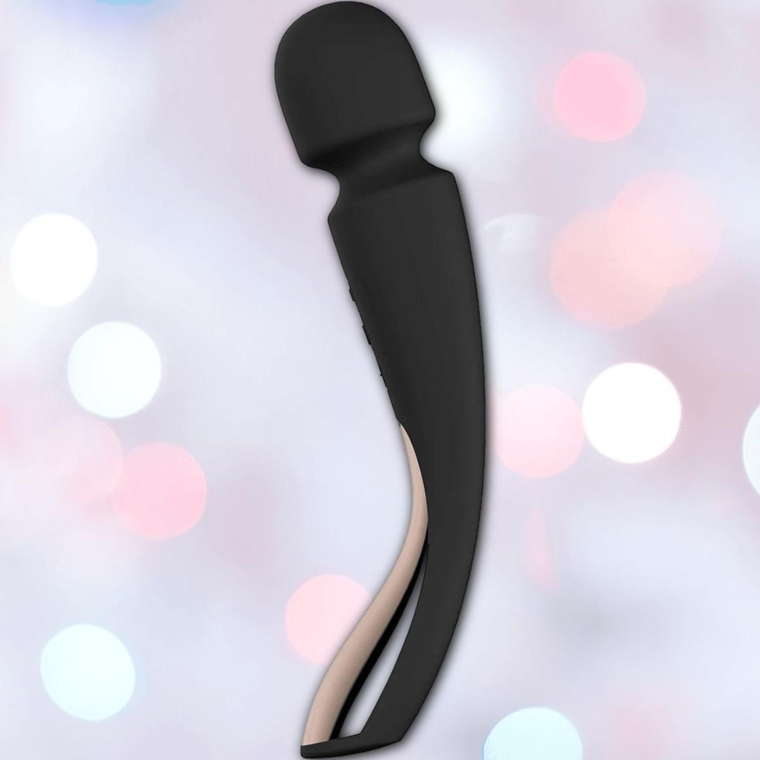 The LELO Smart Wand 2 Medium Personal Wand Massager by LELO, shown in sleek black with a curved design and rounded head, is waterproof and built for comfort and versatile use. The product is displayed against soft pink and white blurred lights.