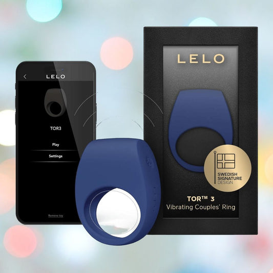 The LELO Tor 3 - Base Blue, a body-safe silicone vibrating couples’ ring, is shown next to its black LELO box and a smartphone displaying the app control screen, set against colorful bokeh lights. 1080