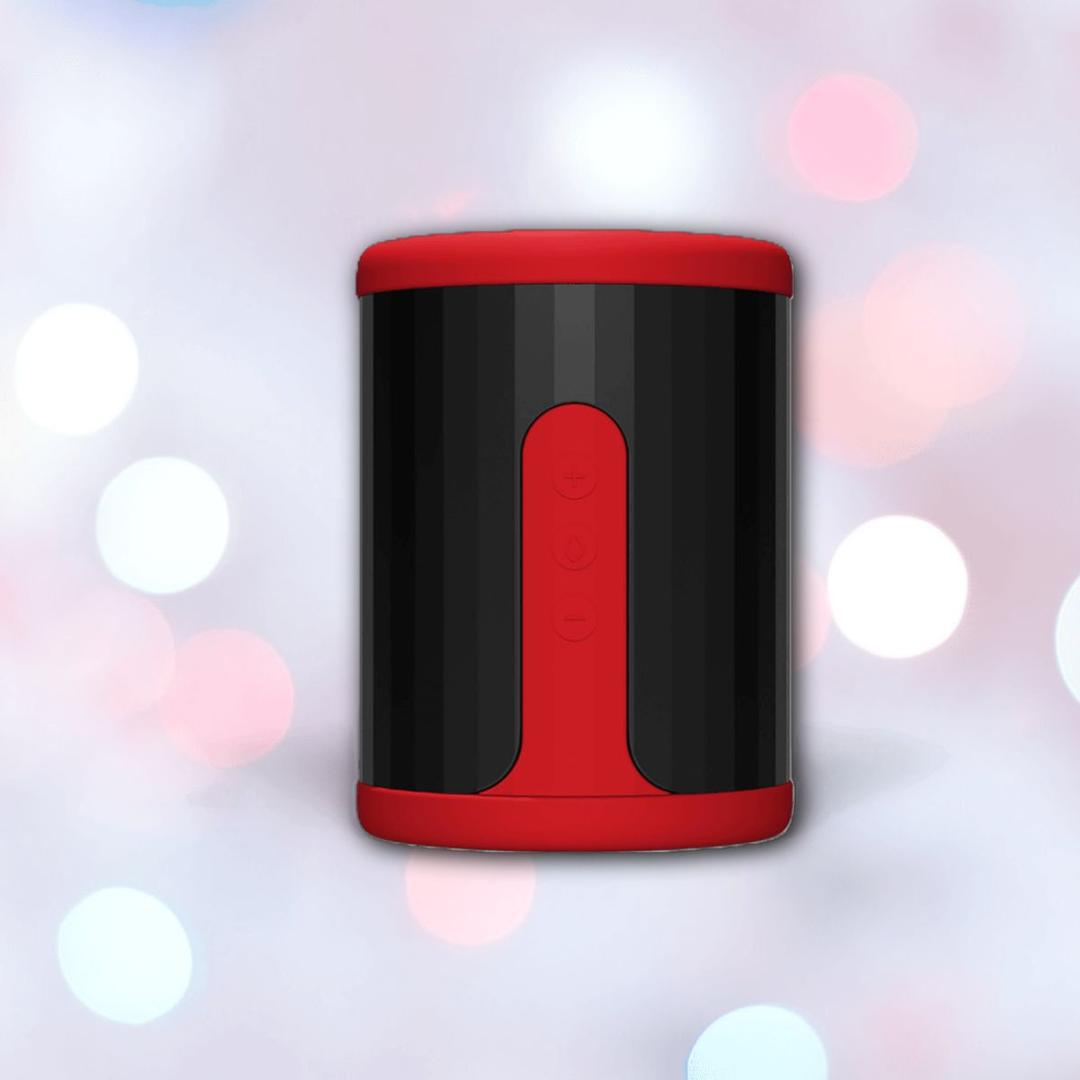 A sleek black cylindrical speaker with red accents and control buttons stands against a blurred bokeh backdrop, its modern design reminiscent of the LELO F2S Massager & Stroker: Dual-Ended Masturbator with App Control - Red by LELO.