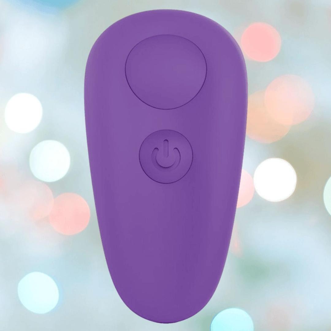 The BMS Leaf + Spirit Panty Vibe in purple features a large circular button and a power symbol, displayed on a blurred pastel background with white and colorful bokeh lights.