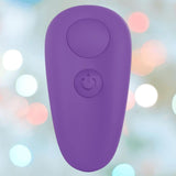 The BMS Leaf + Spirit Panty Vibe in purple features a large circular button and a power symbol, displayed on a blurred pastel background with white and colorful bokeh lights.