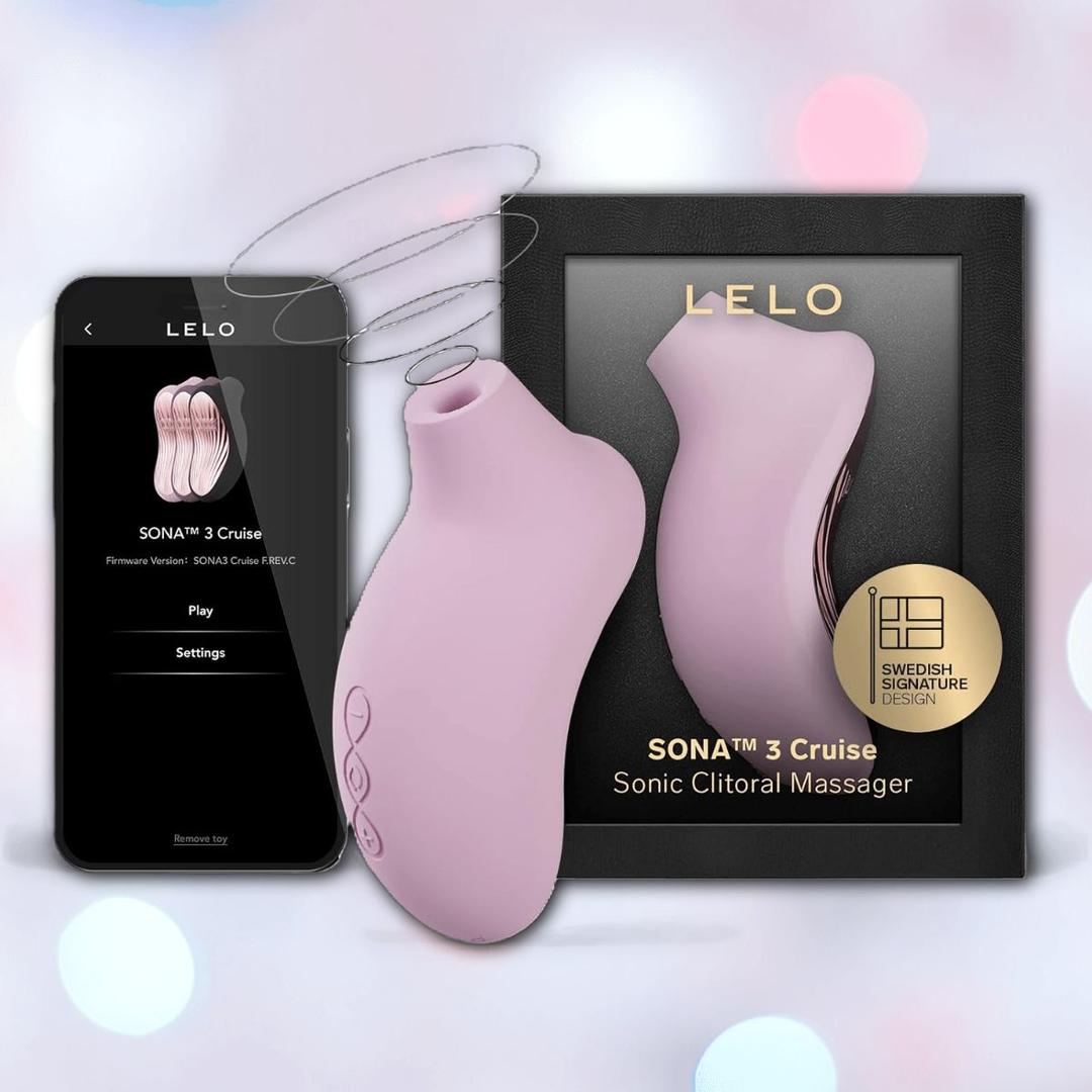 The LELO Sona 3 Cruise - Soft Pink, a sonic clitoral massager from LELO, is shown alongside its black box and a smartphone displaying the app interface, set against a softly blurred background with pastel circles.