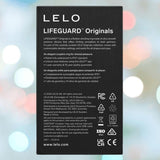 The back of the LELO LIFEGUARD Originals Purple box highlights features, specs, warranty, company info, safety icons, and a website on a soft blue and pink bokeh background.