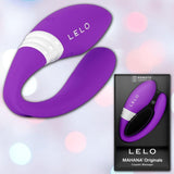 The LELO MAHANA Originals Purple couples massager is displayed next to its branded packaging, which shows the device and the product name on a softly blurred background.