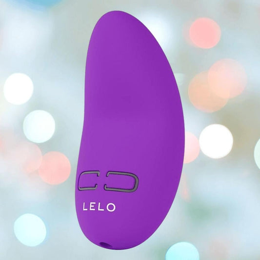 The LELO NEA Originals Purple personal massager features two black control buttons, displayed against a soft, pastel bokeh background. 1080