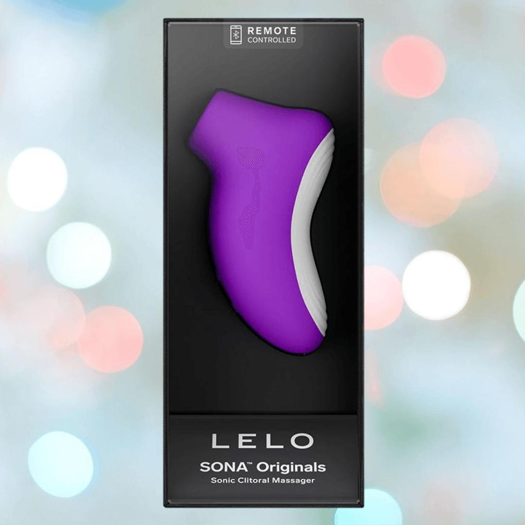 A boxed LELO SONA Originals Purple by LELO sits against a softly blurred, colorful background, with a black and clear display front and "remote controlled" labeling.