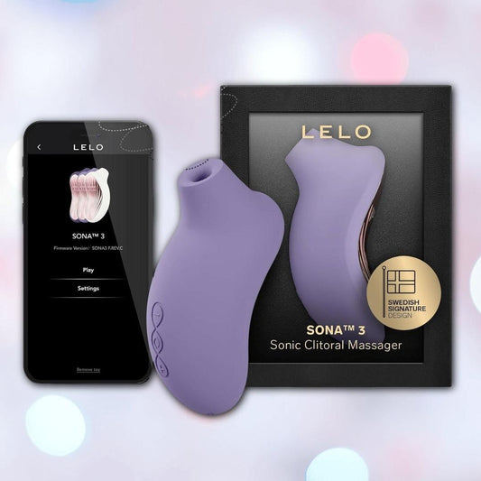 The LELO Sona 3 - Violet Dusk, featuring SenSonic technology, is shown next to its sleek black box and a smartphone displaying the LELO app. A softly blurred pastel glow enhances the background. 1080