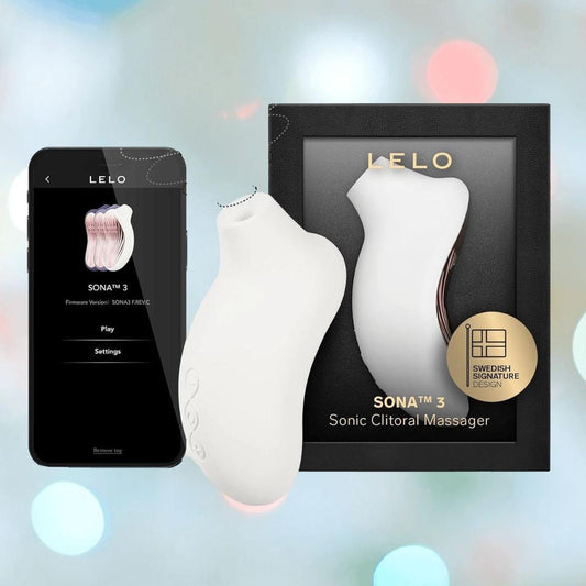 A LELO Sona 3 - Cream by LELO is displayed beside its black box and a smartphone featuring the LELO app, set against a softly blurred background with blue and pink lights. 1080