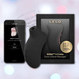 The LELO Sona 3 Cruise - Black, a body-safe silicone sonic clitoral massager, is shown beside its packaging and a smartphone displaying the device's control app.