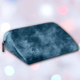 The Liberator Jaz Ibiza Collection - Ocean Blue by Liberator, a velvety wedge-shaped pillow with a small black tag, is displayed against a softly blurred background with pastel-hued circles.