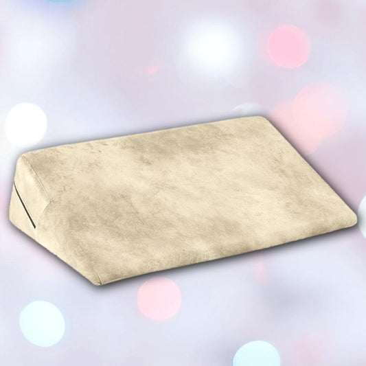 The Liberator Wedge Ibiza Collection - Natural by Liberator is shown in beige with a soft texture against a blurred pastel background featuring white, pink, and blue bokeh lights. 1080