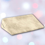 The Liberator Wedge Ibiza Collection - Natural by Liberator is shown in beige with a soft texture against a blurred pastel background featuring white, pink, and blue bokeh lights.