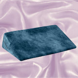 The Liberator Wedge Ibiza Collection - Ocean Blue by Liberator sits atop a light pink, silky, and slightly wrinkled fabric background.