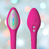 The Lovense Lush 4 Remote Controlled Egg Vibrator by Lovense includes two ergonomic pink silicone devices: one with a metallic surface and rainbow strip, the other with two buttons. Ideal as G-Spot vibrators, they offer Bluetooth remote control amid softly blurred colorful lights.